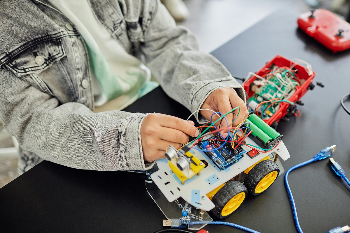 boy working on a partially assembled toy truck